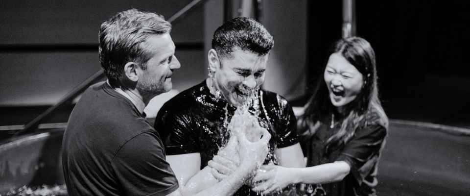 A man is baptized by two people.
